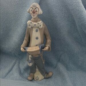 Casades or Napcoware porcelain clown figurine playing an accordion.